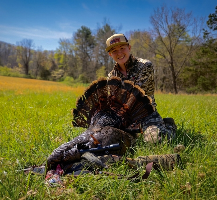 Judah outdoors with a whitetail buck