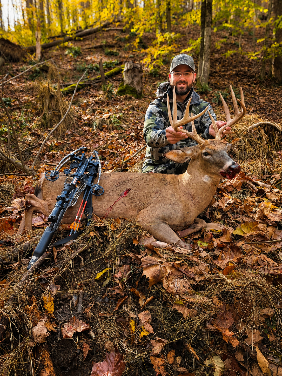 Tyler outdoors with a whitetail buck